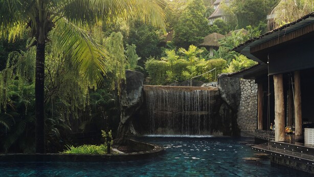 A tropical resort with a waterfall, a pool, and lush greenery. - Keemala (Kamala)