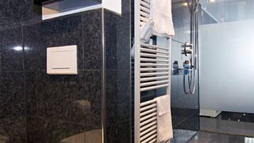 Shower, designer toiletries, hair dryer, towels