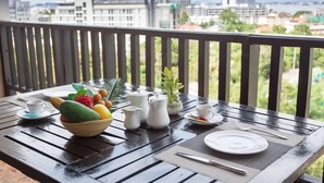 A table set for breakfast on a balcony with a city view. - Essential Pattaya (Pattaya)