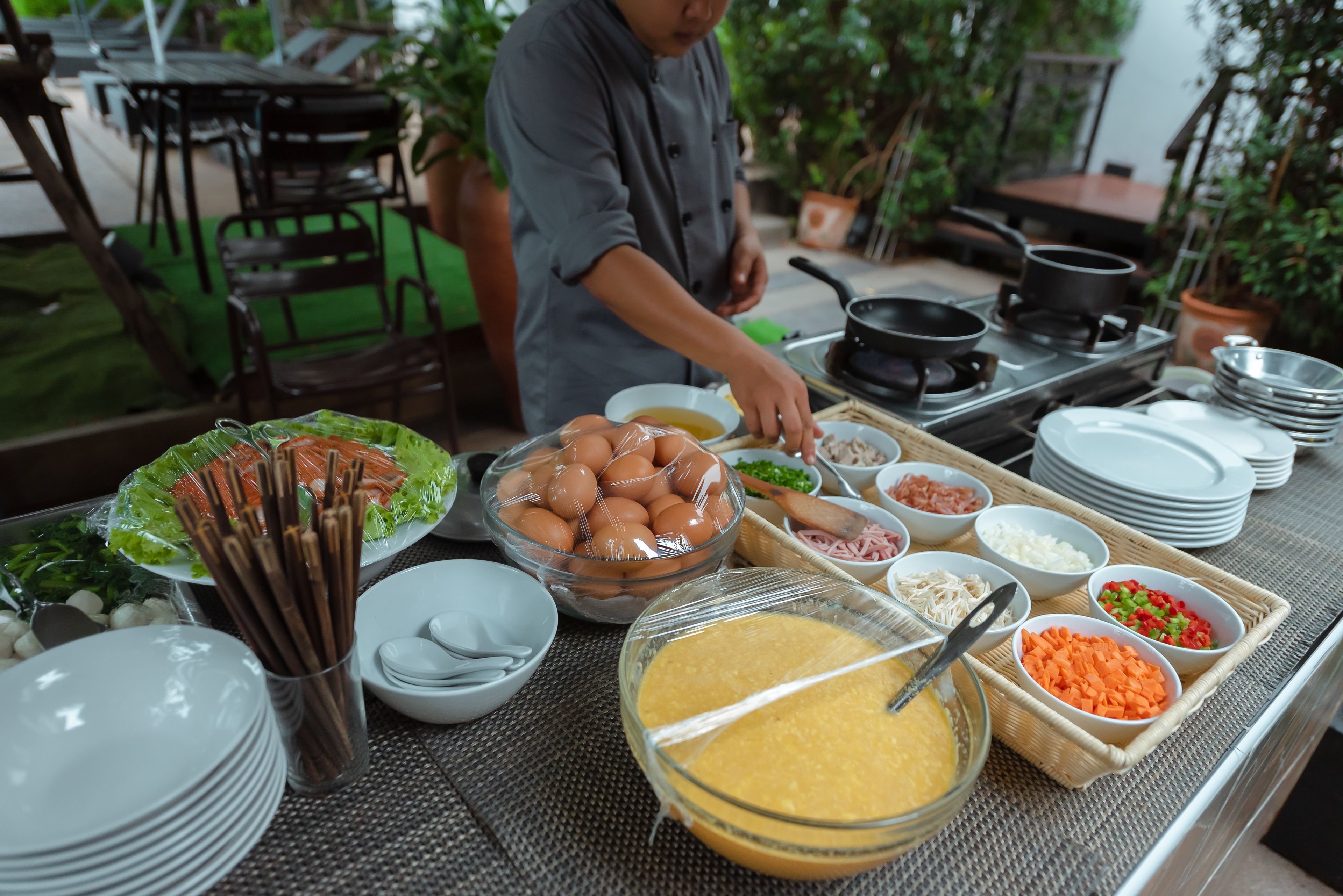 A buffet setup with various food items and utensils.