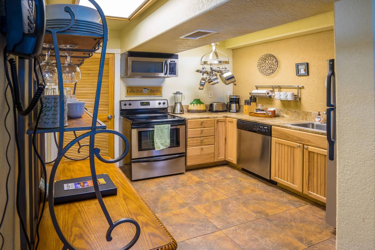 A compact kitchen with a microwave, stove, and dishwasher.