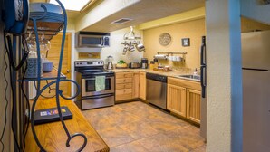 A compact kitchen with a microwave, stove, and dishwasher.