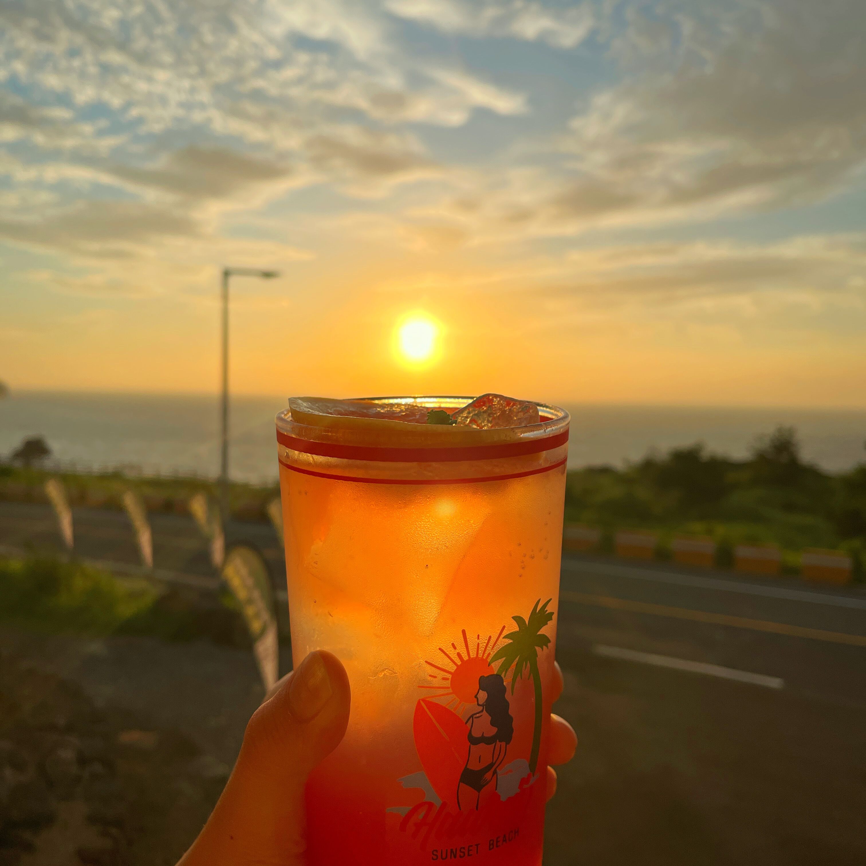 A sunset view with a drink in hand.