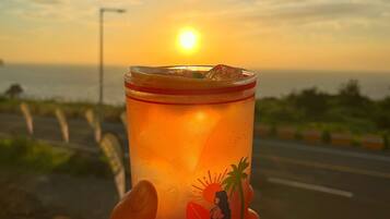 A sunset view with a drink in hand.