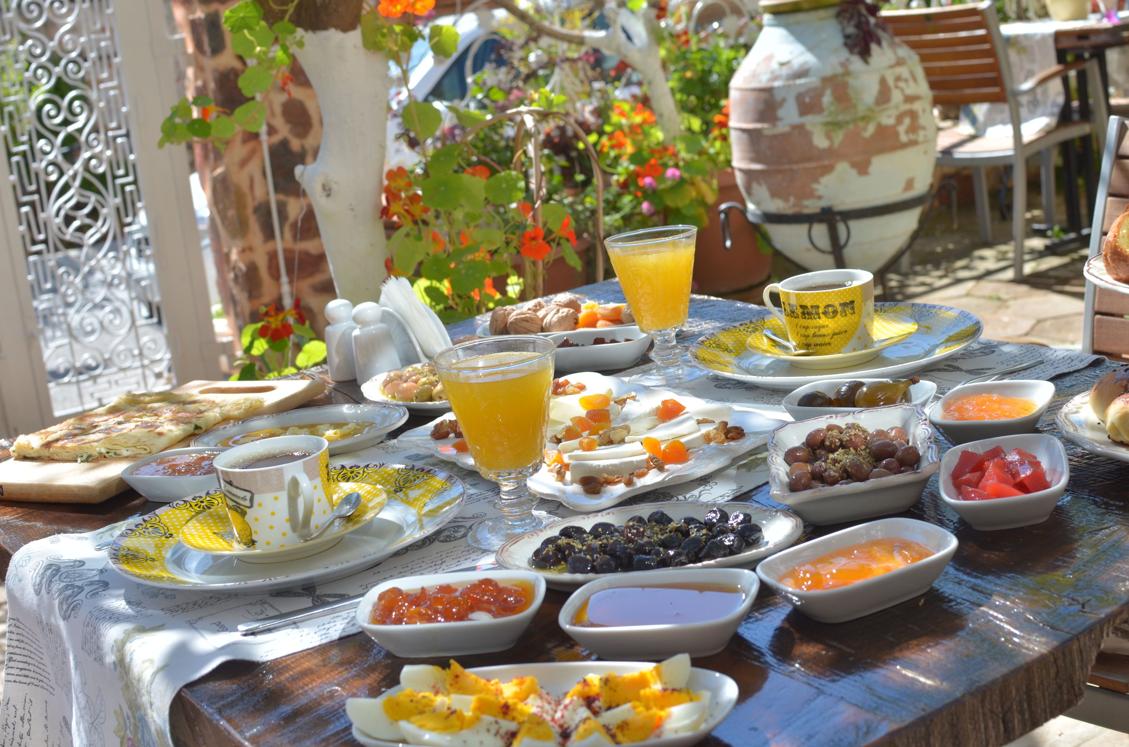 A table set with various breakfast items including fruits, bread, and beverages.