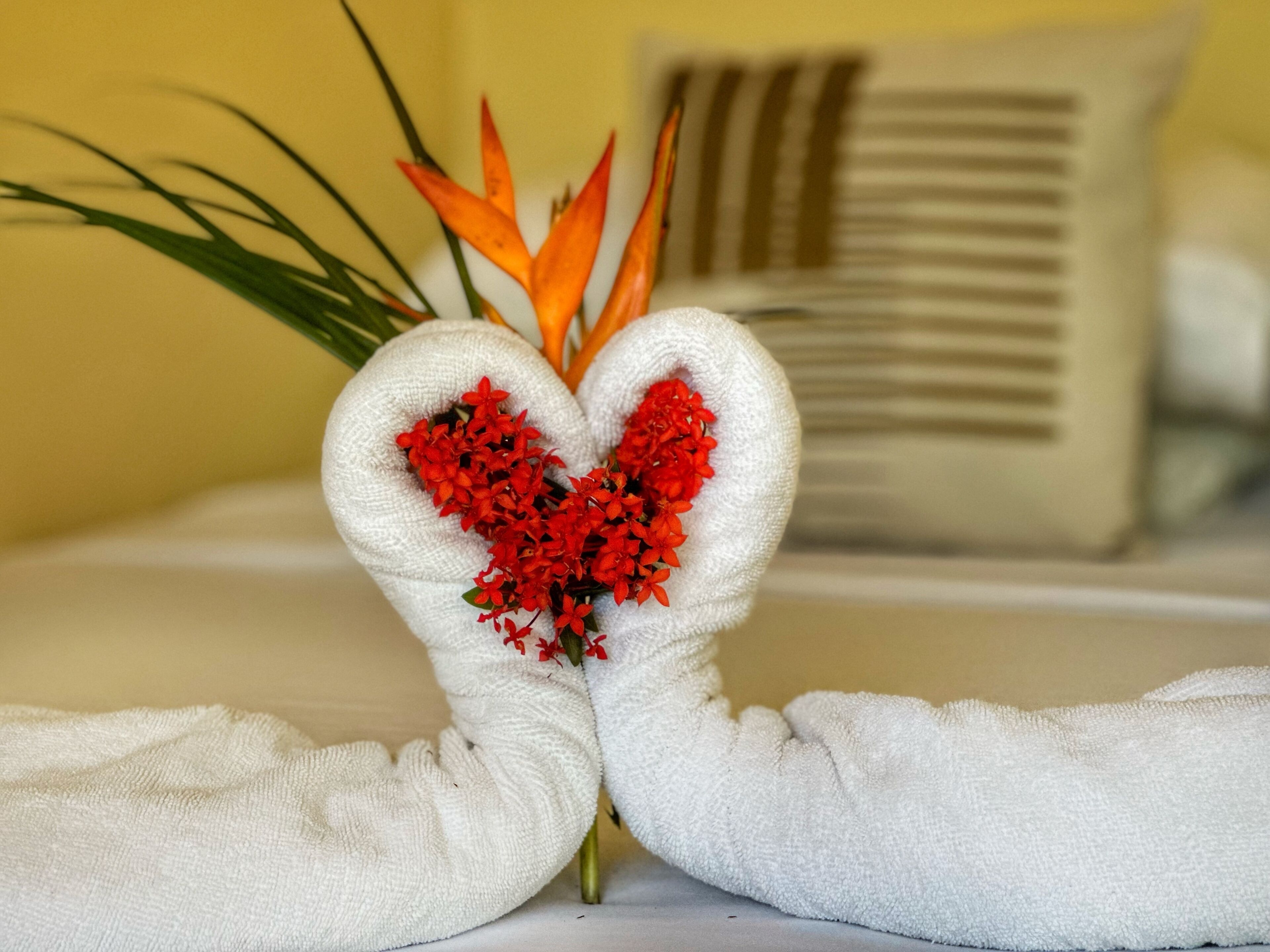 A pair of towels with heart-shaped floral arrangements.