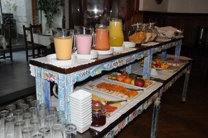 A buffet table with various food items and beverages.