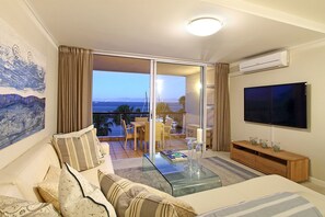 Apartment, 2 Bedrooms | Living room | 60-inch flat-screen TV with satellite channels, TV - Aqua Views (Cape Town)