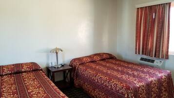 Desk, iron/ironing board, bed sheets