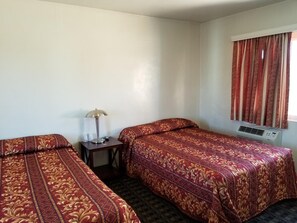 Desk, iron/ironing board, bed sheets