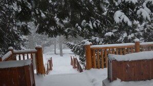A snow-covered wooden gate leading to a pathway. - Heather Lodge (Minden Hills)