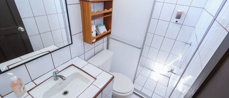 A bathroom with a sink, toilet, and shower.