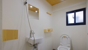 A small bathroom with a toilet, a sink, a shower, and a window. - 英倫旅店 - Baker Street Guesthouse (Tainan)