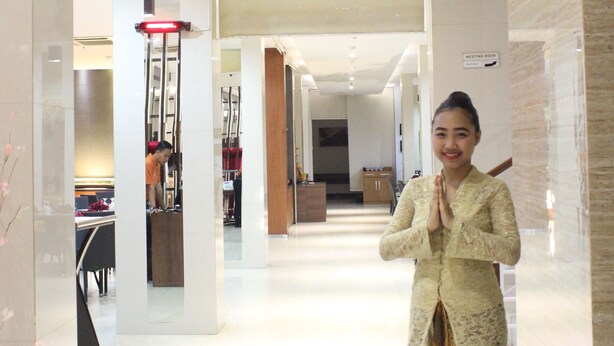 A woman in traditional attire standing in front of a restaurant named 'SINGGALANG'. - Sahid Mutiara Karawaci (Curug)