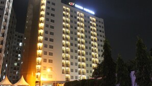 A multi-story hotel building with illuminated balconies and a sign reading "Samir Hotel". - Sahid Mutiara Karawaci (Curug)