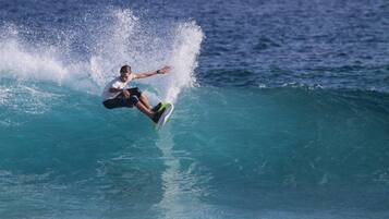 Guests can enjoy thrilling surfing experiences in the ocean.