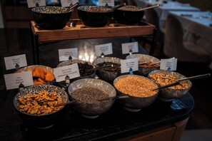 A buffet with various food items labeled, including nuts, seeds, and legumes. - Soleil Alpine Lifestyle Hotel (Badia)