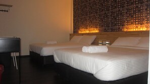 A hotel room with two beds, a wooden headboard, and a wall with a patterned design. - Dream Garden Hotel (Klang)