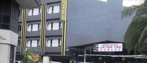 A hotel with a modern design, featuring a prominent 'HOTEL' sign on the facade.