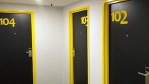 A hallway with three doors numbered 104, 103, and 102. - Dream Garden Hotel (Klang)
