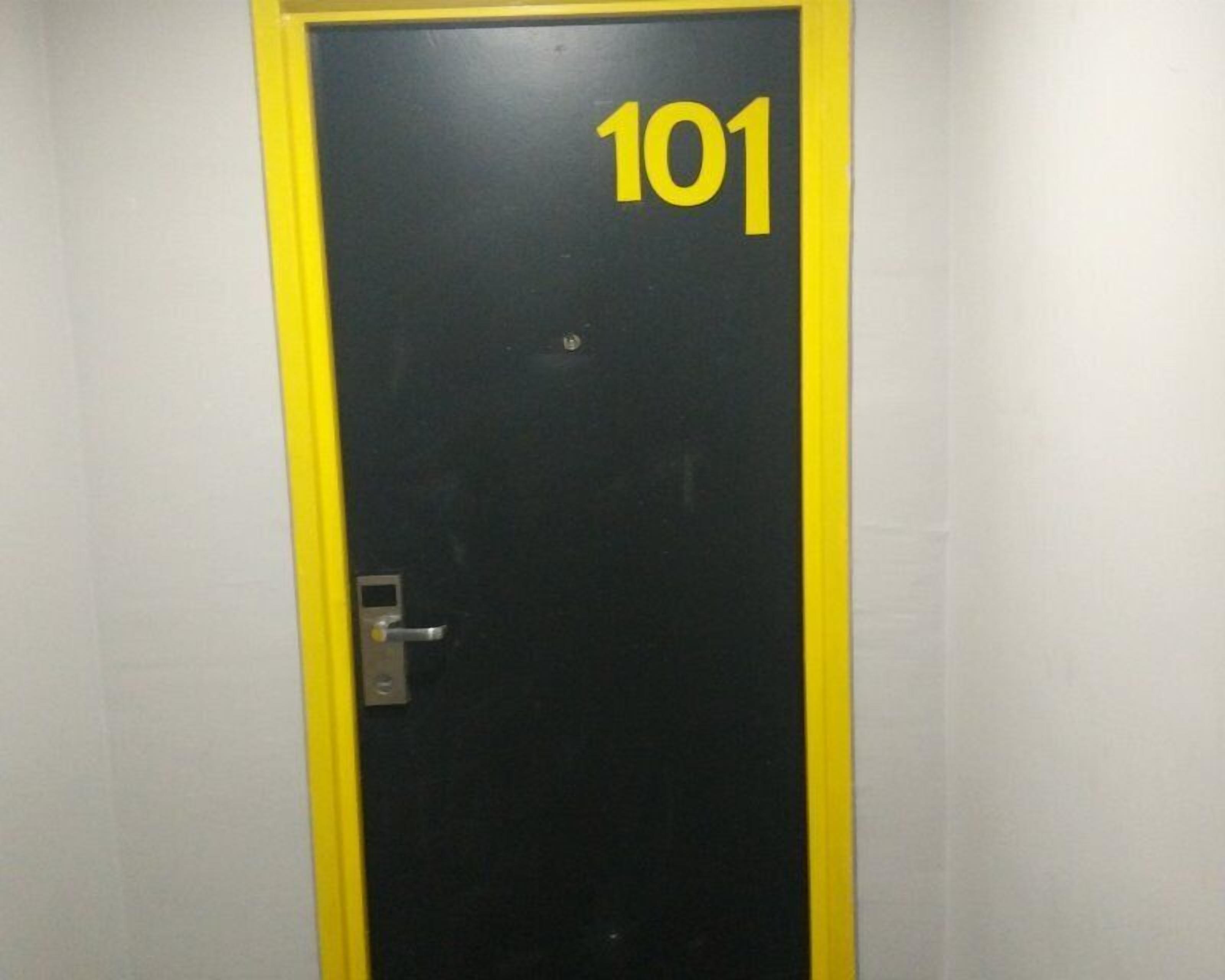 A door with the number 101 on it, a door handle, and a lock.