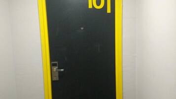 A door with the number 101 on it, a door handle, and a lock.