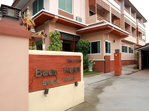 A multi-story building with a sign indicating 'Bae Hotel' and 'Bae Hotel Suites'. - Baanmalai Hotel Chiangrai (Chiang Rai)