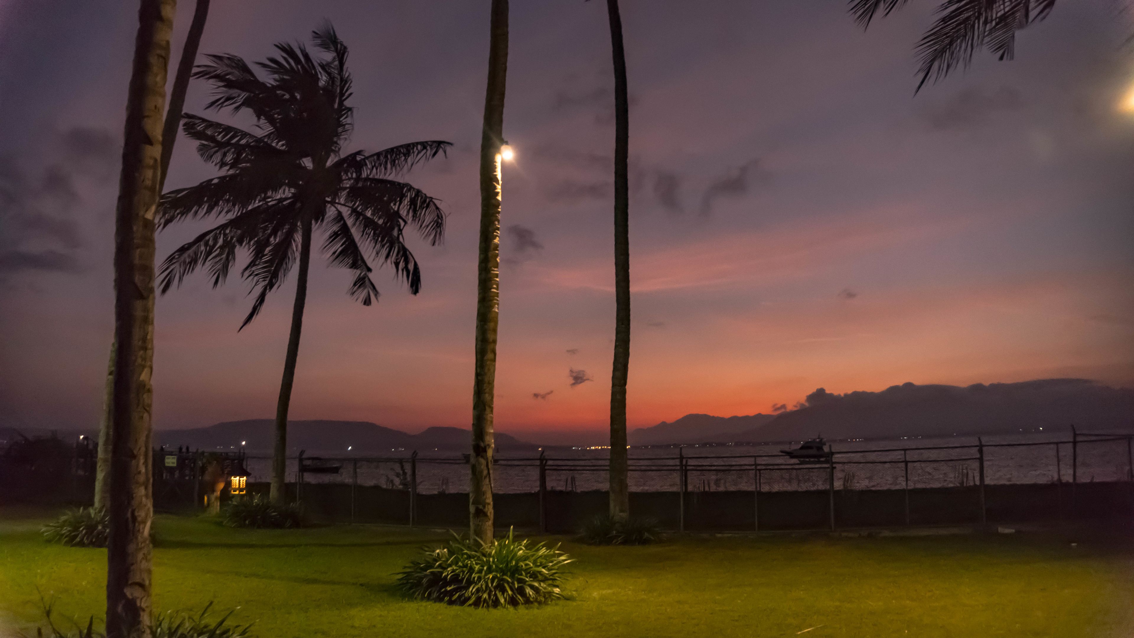 on the beach, black sand, beach umbrellas, beach towels