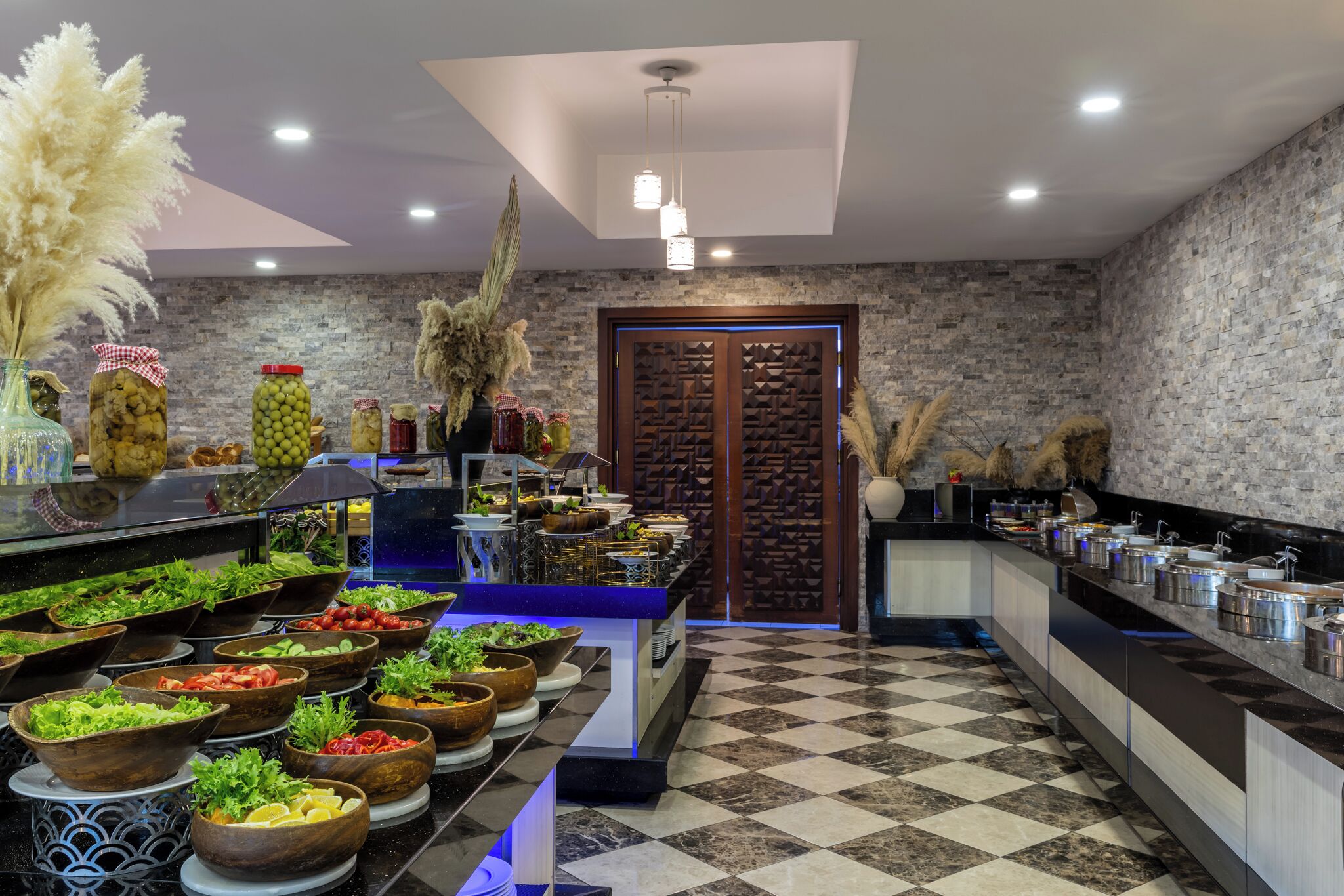 A buffet setup with various food items and a checkered floor pattern.