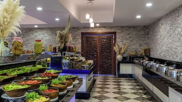 A buffet setup with various food items and a checkered floor pattern.