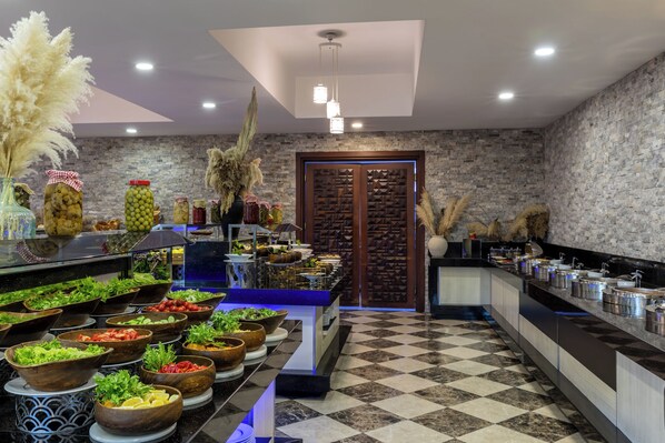 A buffet setup with various food items and a checkered floor pattern.