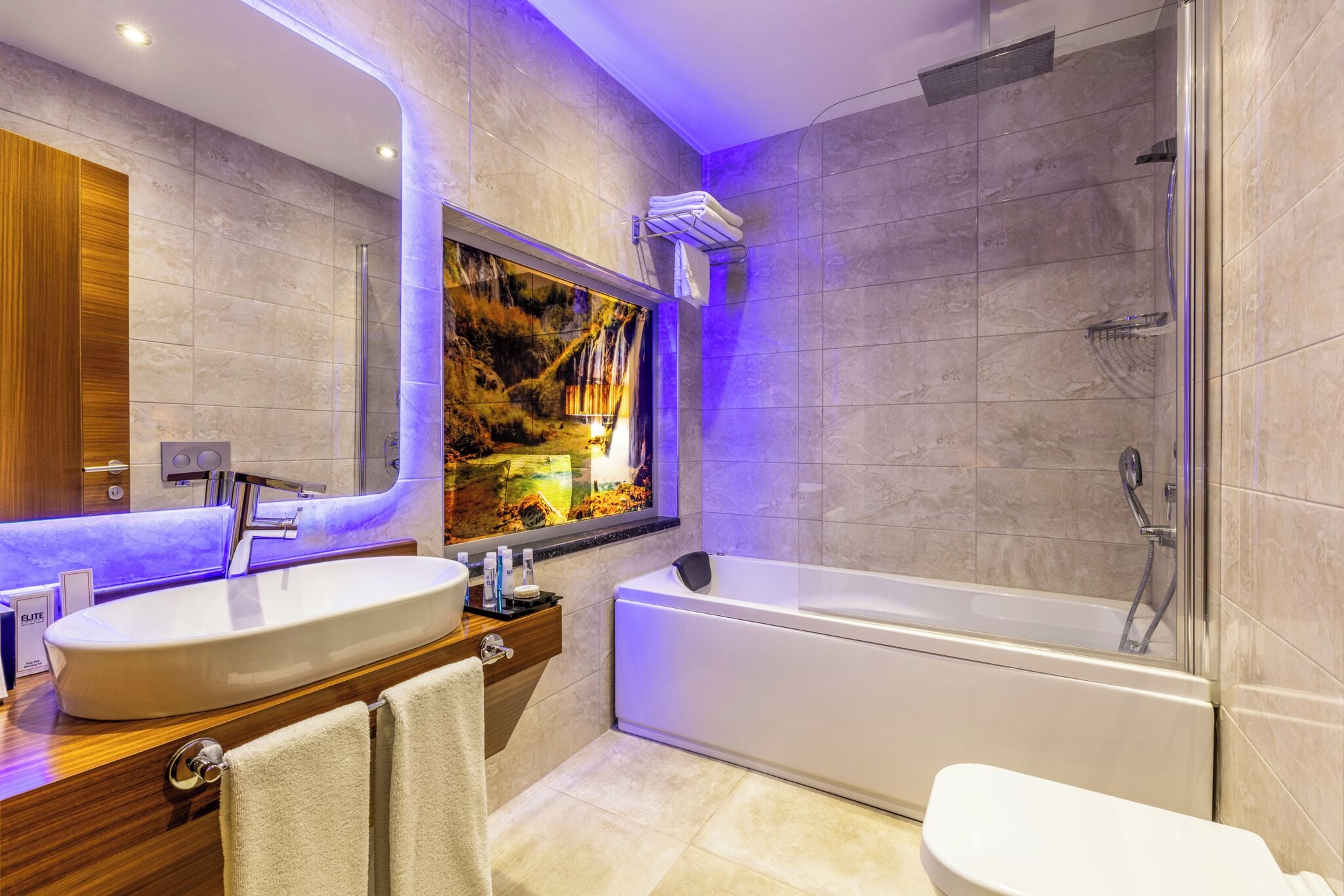 A modern bathroom with a large sink, bathtub, and shower.