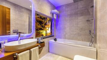 A modern bathroom with a large sink, bathtub, and shower.