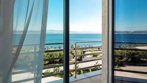 A balcony with a clear view of the sea and distant mountains.