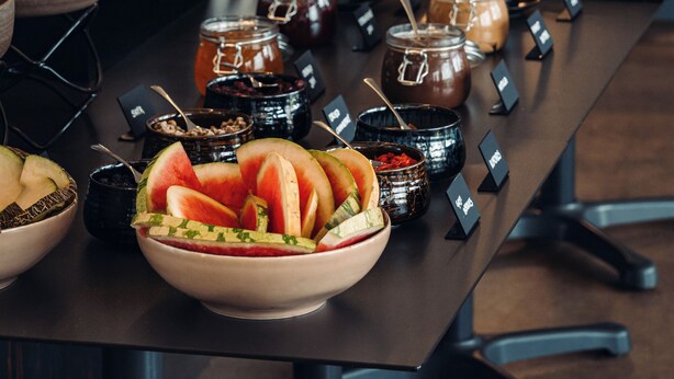 A buffet setup with various food items and condiments. - Geo Hotel Grindavik (Grindavik)