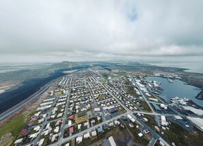 An aerial view of a residential area with houses, roads, and a marina.
