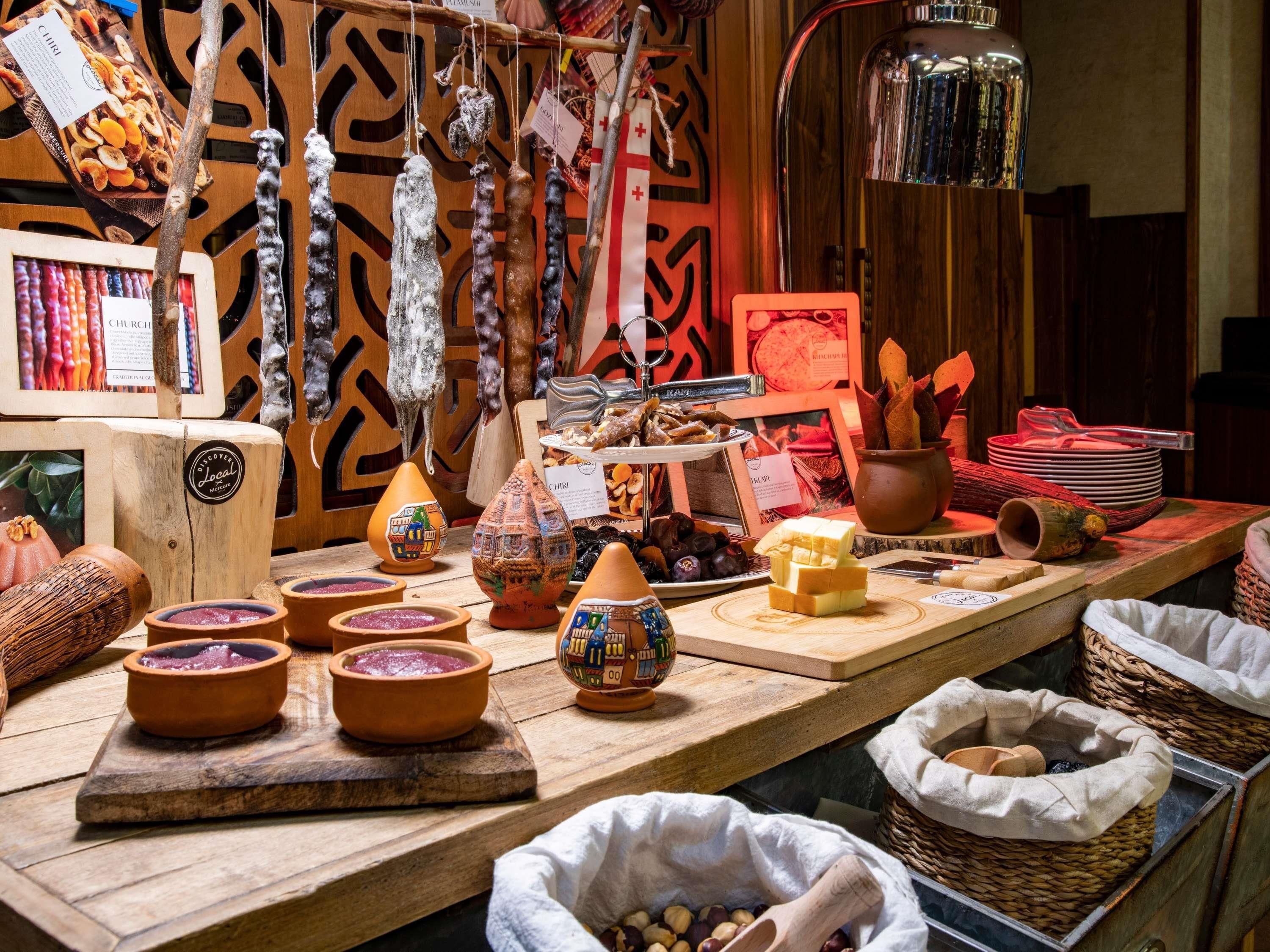 A display of food items and pottery at a market stall.