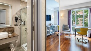 A modern bathroom with a glass shower, a vanity with a mirror, and a sink.