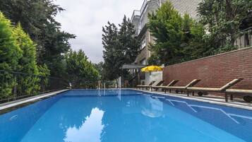 Seasonal outdoor pool, open 8:00 AM to 8:00 PM, pool umbrellas