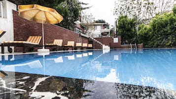 Seasonal outdoor pool, open 8:00 AM to 8:00 PM, pool umbrellas