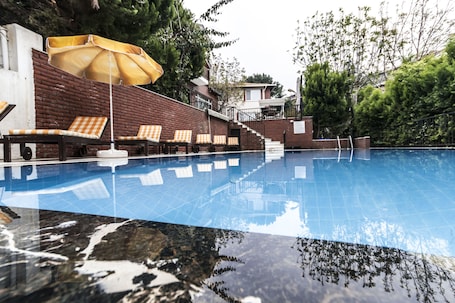 Seasonal outdoor pool, open 8:00 AM to 8:00 PM, pool umbrellas