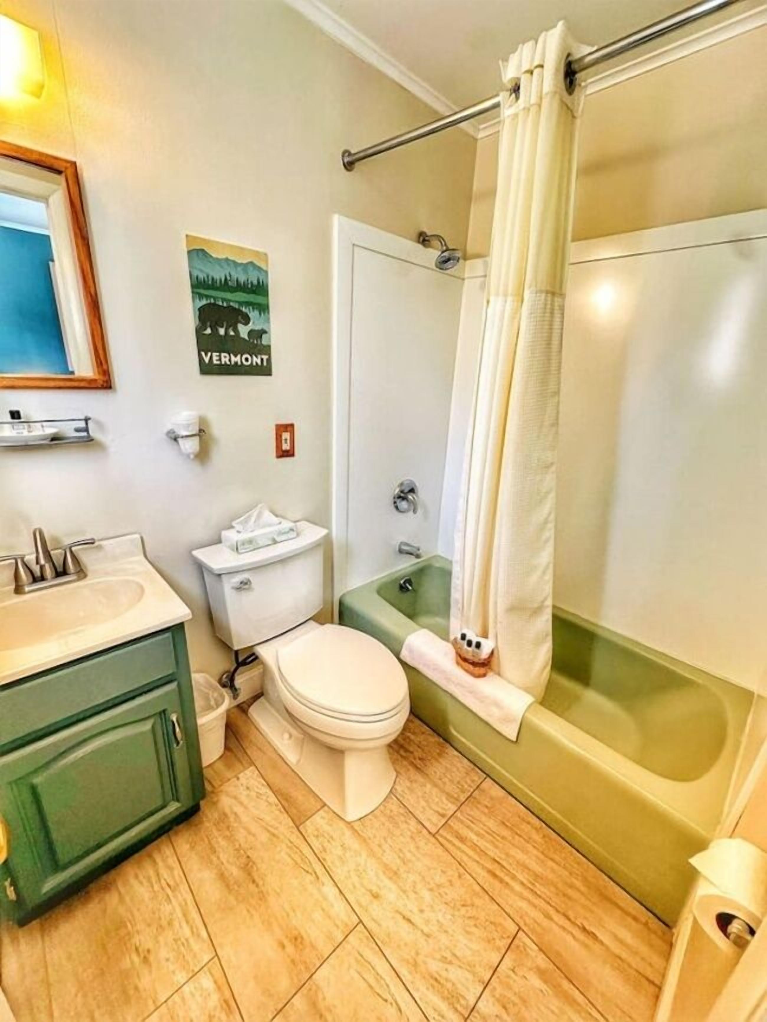 A bathroom with a toilet, sink, and bathtub.