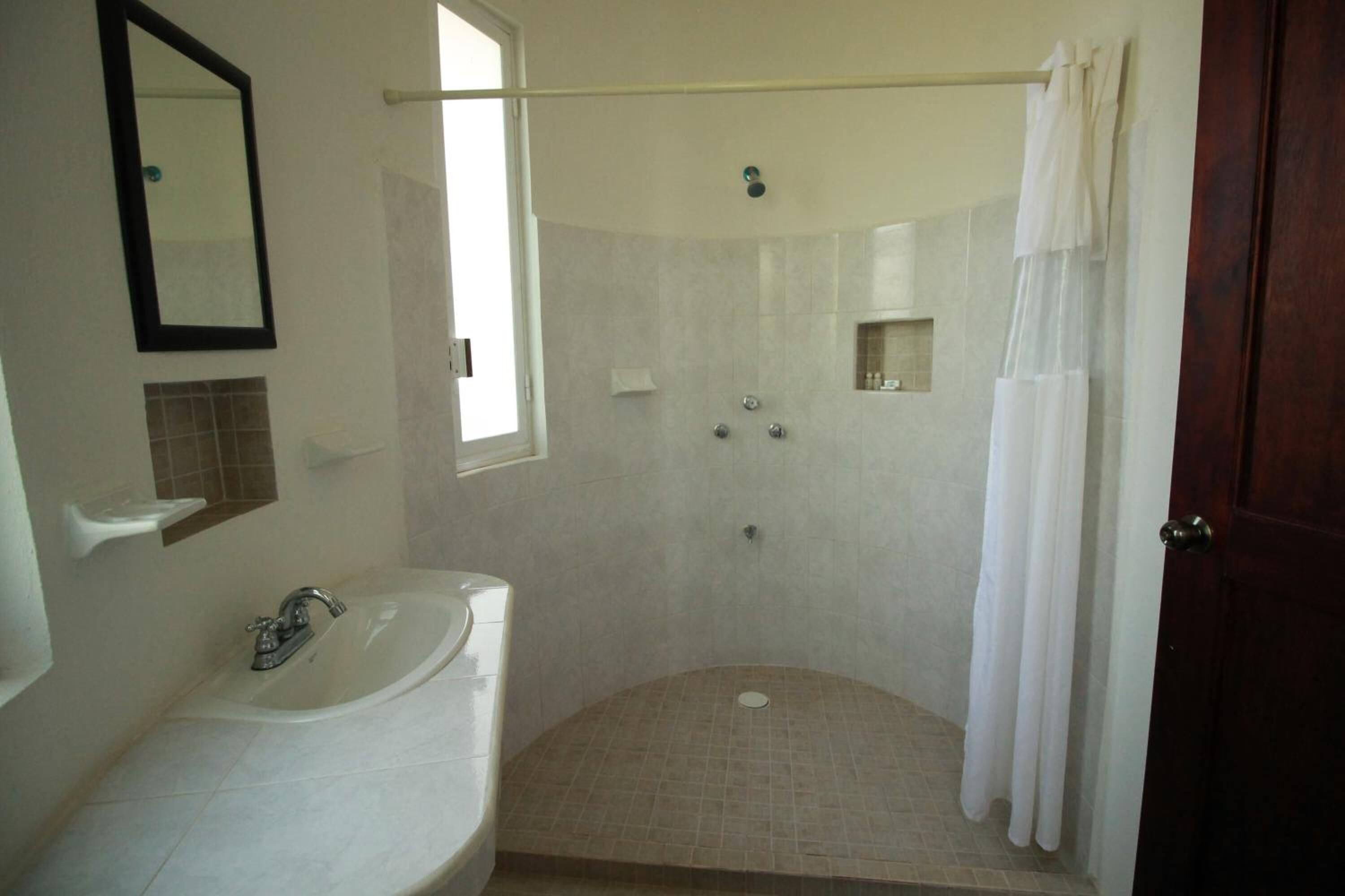 A bathroom with a bathtub, a shower, and a toilet.