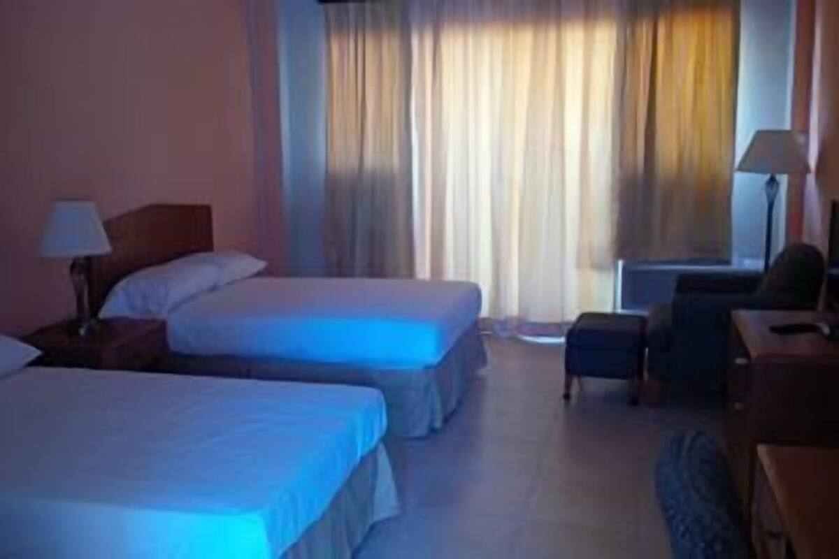 Standard Double Room, 2 Queen Beds, Pool View | 1 bedroom, in-room safe, desk, iron/ironing board