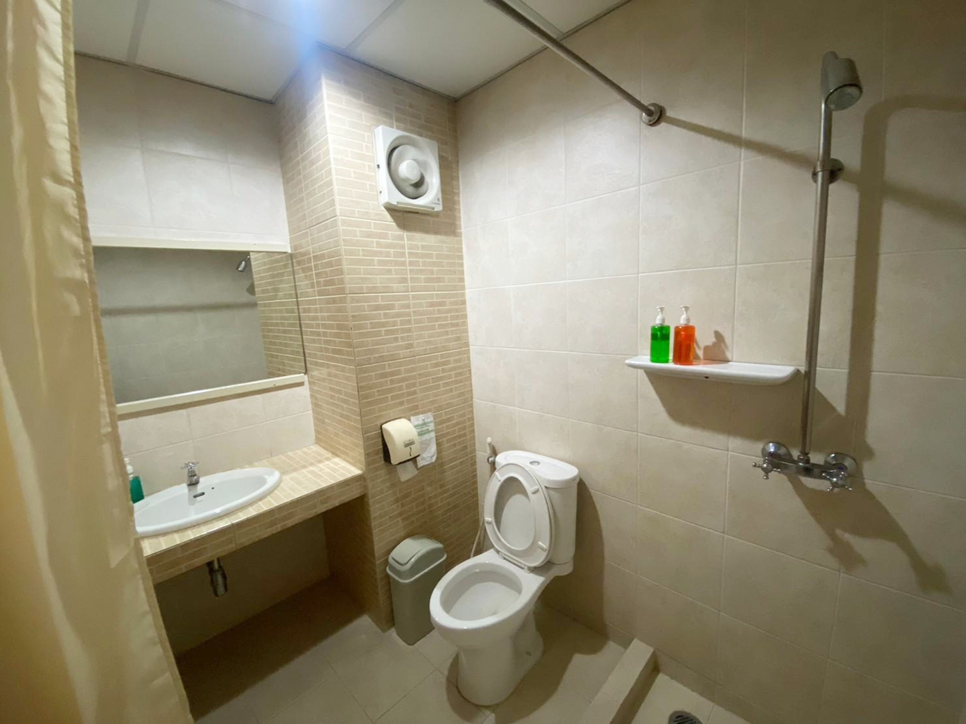 A bathroom with a sink, toilet, and shower.