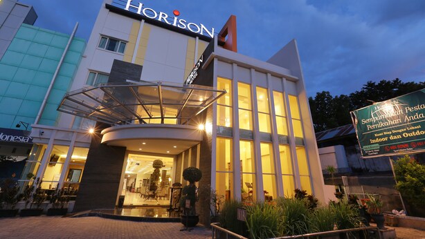 A modern hotel with a prominent 'Horizon' sign, large windows, and a well-lit entrance. - Horison Kendari (Kendari)