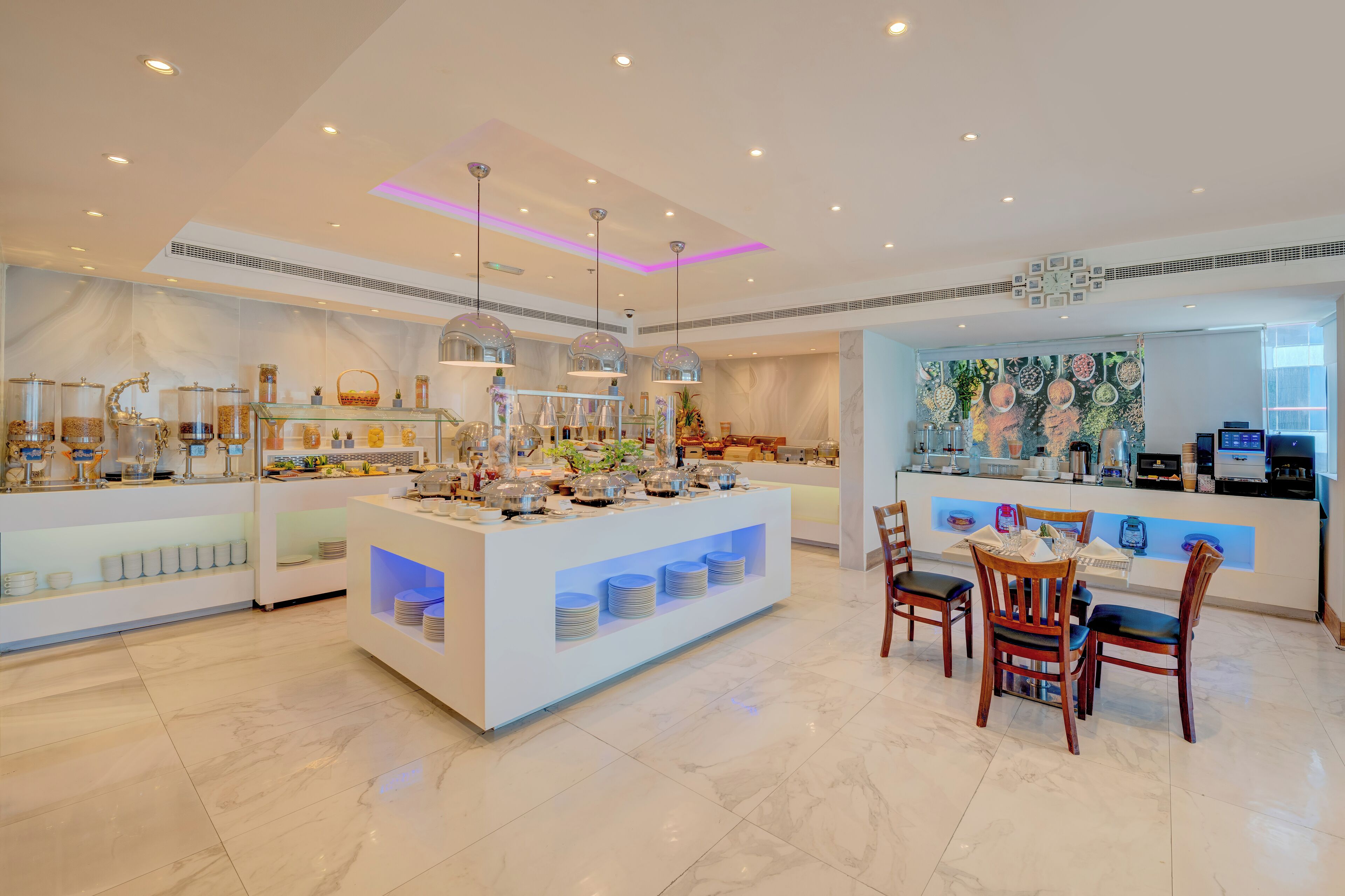 A modern hotel lobby with a central island counter, seating area, and decorative elements.