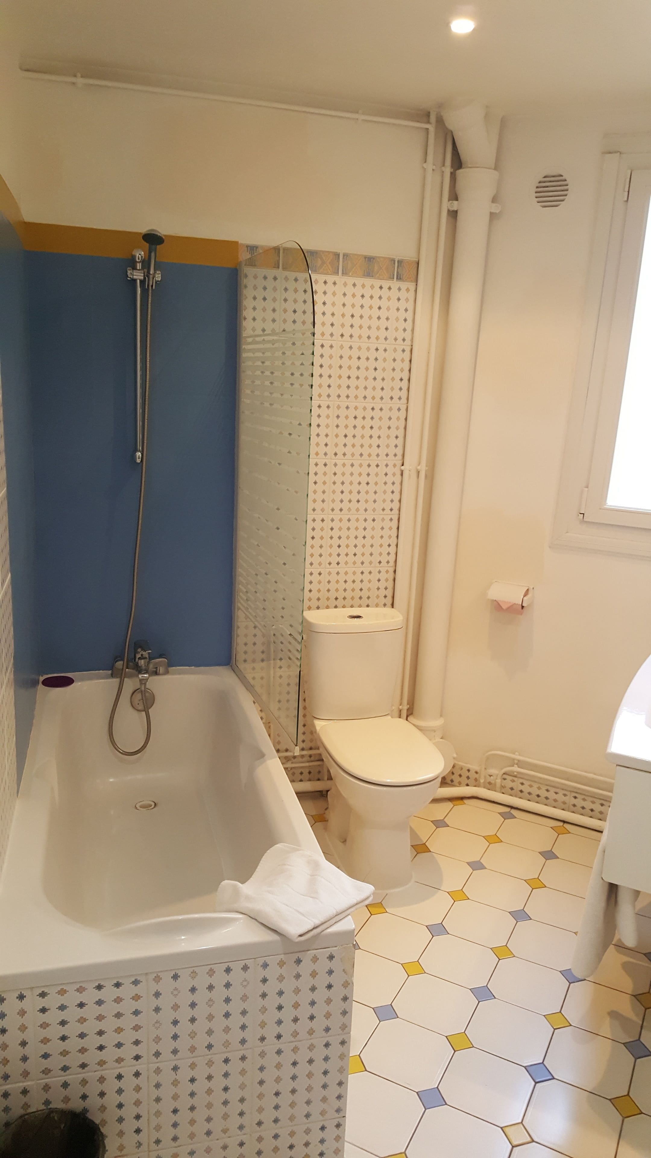 A bathroom with a bathtub, toilet, and shower.