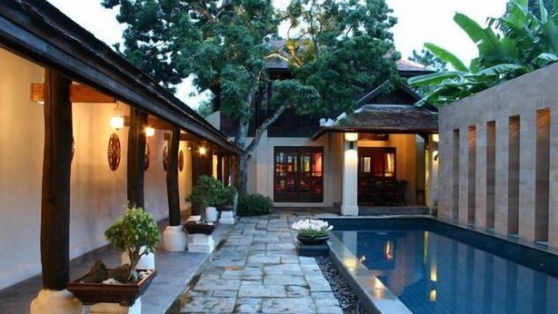 A courtyard with a swimming pool, stone pathway, and potted plants. - Bann Tazala Exclusive Residence (Chiang Mai)