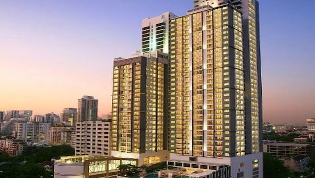 A high-rise hotel with multiple floors, a rooftop pool, and a cityscape view. - 39 Boulevard Executive Residence (Bangkok)